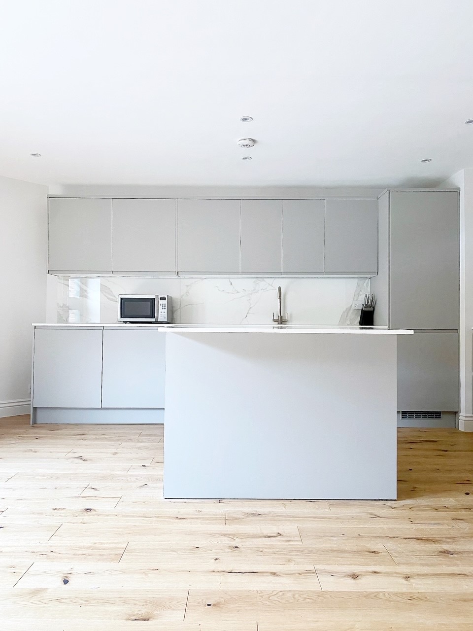 Light grey kitchen in rental flat